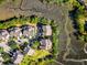 An overhead shot of luxury homes in an upscale neighborhood near winding streams, lush landscaping, and a community boardwalk at 2087 Sterling Marsh Ln, Seabrook Island, SC 29455