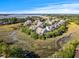 A scenic overhead view showcases homes in a private community near peaceful streams and a marsh boardwalk to the coastline at 2087 Sterling Marsh Ln, Seabrook Island, SC 29455