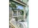Relaxing outdoor balcony space with comfortable lounge seating, a table, and palm tree views at 2087 Sterling Marsh Ln, Seabrook Island, SC 29455