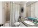 Inviting bathroom with granite countertop, neutral tile, and a shower/tub combo with decorative curtain at 2087 Sterling Marsh Ln, Seabrook Island, SC 29455