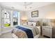 Cozy bedroom featuring a queen-size bed, large window with white shutters, and neutral wall color at 2087 Sterling Marsh Ln, Seabrook Island, SC 29455