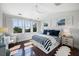 Bright bedroom with a vaulted ceiling, many windows, hardwood floors, and a striped bedspread at 2087 Sterling Marsh Ln, Seabrook Island, SC 29455
