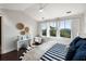 Brightly lit bedroom showcasing three windows, hardwood floors, and a desk area, perfect for relaxation at 2087 Sterling Marsh Ln, Seabrook Island, SC 29455