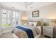 Cozy bedroom featuring a queen-size bed, large window with white shutters, and neutral wall color at 2087 Sterling Marsh Ln, Seabrook Island, SC 29455
