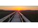 Scenic boardwalk extending over marsh grasses towards the sunset, inviting peaceful walks at 2087 Sterling Marsh Ln, Seabrook Island, SC 29455