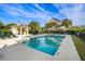 Enjoy the refreshing community pool with ample seating, surrounded by a well-maintained fence and tropical palm trees at 2087 Sterling Marsh Ln, Seabrook Island, SC 29455