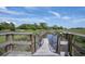 Scenic view of a wooden dock with a pathway to the marsh at 2087 Sterling Marsh Ln, Seabrook Island, SC 29455