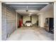 Spacious two car garage with painted brick walls, overhead lighting, and an installed door lift at 2087 Sterling Marsh Ln, Seabrook Island, SC 29455