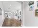 Bright, long hallway displays captivating artwork along the walls at 2087 Sterling Marsh Ln, Seabrook Island, SC 29455