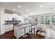Contemporary kitchen with sleek white cabinets, granite counters, and an open layout leading to the living area at 2087 Sterling Marsh Ln, Seabrook Island, SC 29455