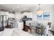 Stylish kitchen featuring granite countertops, stainless appliances, and an adjacent dining area with a chandelier at 2087 Sterling Marsh Ln, Seabrook Island, SC 29455