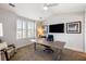 Home office with a large desk, comfortable seating, and ample natural light offers a productive workspace at 2087 Sterling Marsh Ln, Seabrook Island, SC 29455