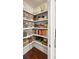 Organized walk-in pantry with shelving stocked with food, containers, and cookbooks offers ample storage space at 2087 Sterling Marsh Ln, Seabrook Island, SC 29455