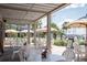 Outdoor patio area with tables and umbrellas overlooking the marina at 2087 Sterling Marsh Ln, Seabrook Island, SC 29455