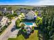 A captivating community pool is surrounded by lush green hedges and palm trees, inviting relaxation at 2087 Sterling Marsh Ln, Seabrook Island, SC 29455
