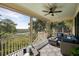 Spacious screened porch with plush seating, stylish decor, and panoramic views of the surrounding landscape at 2087 Sterling Marsh Ln, Seabrook Island, SC 29455