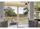 Inviting screened porch featuring beautiful views, wicker furniture, and a stylish ceiling fan at 2087 Sterling Marsh Ln, Seabrook Island, SC 29455