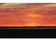 Vibrant orange sunset casting a warm glow over the marsh and horizon at 2087 Sterling Marsh Ln, Seabrook Island, SC 29455