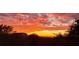 Dramatic sunset view overlooking the marsh with brilliant orange and red hues, framed by trees at 2087 Sterling Marsh Ln, Seabrook Island, SC 29455