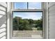 An expansive view featuring marshland and trees captured through a large window, showcasing natural beauty at 2087 Sterling Marsh Ln, Seabrook Island, SC 29455