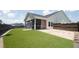 Manicured backyard with an artificial turf and a screened porch at 209 Country Gate Ln, Summerville, SC 29485