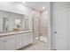 Well-lit bathroom with granite countertops, dual sinks and glass shower with decorative tile at 209 Country Gate Ln, Summerville, SC 29485