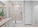 Well-lit bathroom with granite countertops, dual sinks and glass shower with decorative tile at 209 Country Gate Ln, Summerville, SC 29485