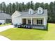 Beautiful single-Gathering home featuring a two-car garage, a covered front porch, and lawn at 209 Country Gate Ln, Summerville, SC 29485
