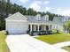Charming home with a covered front porch and well-maintained landscaping at 209 Country Gate Ln, Summerville, SC 29485