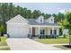 Charming home featuring a two-car garage, a covered porch, and a well-manicured lawn at 209 Country Gate Ln, Summerville, SC 29485