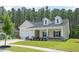 Charming home with a welcoming front porch, two-car garage, and manicured landscaping at 209 Country Gate Ln, Summerville, SC 29485