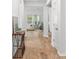 Hallway featuring light-colored wood floors with view to a living space and an area rug at 209 Country Gate Ln, Summerville, SC 29485