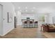 Open-concept kitchen features white cabinets, island with seating, and stainless steel appliances at 209 Country Gate Ln, Summerville, SC 29485