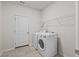 A functional laundry room with a washer, dryer, and storage shelves at 209 Country Gate Ln, Summerville, SC 29485