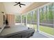 An inviting screened-in porch with a swing and view of the backyard at 209 Country Gate Ln, Summerville, SC 29485