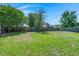 Expansive backyard with lush green grass and a wooden fence, providing ample space for recreation and privacy at 216 Goldfinch Ln, Summerville, SC 29485