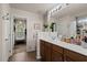 Bright bathroom with a view into walk-in closet and another bathroom, featuring a long vanity and plenty of counter space at 216 Goldfinch Ln, Summerville, SC 29485