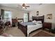 A primary bedroom boasts dark furniture, two windows offering natural light and creating a tranquil retreat at 216 Goldfinch Ln, Summerville, SC 29485