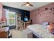 A charming bedroom with a ceiling fan, and whimsical decor, featuring Disney-themed decorations and a cozy atmosphere at 216 Goldfinch Ln, Summerville, SC 29485