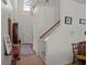 Bright foyer featuring tile flooring, a staircase, and a high ceiling with a window, creating an open entrance at 216 Goldfinch Ln, Summerville, SC 29485