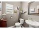 Stylish half bathroom featuring a pedestal sink and decorative mirror at 216 Goldfinch Ln, Summerville, SC 29485