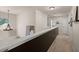Upstairs hallway with chandelier and artwork and dark brown railing at 216 Goldfinch Ln, Summerville, SC 29485