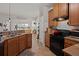 Kitchen boasts oak cabinets, black appliances, and opens into a workout area at 216 Goldfinch Ln, Summerville, SC 29485