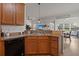 An oak kitchen overlooking the workout room and living area, fostering a sense of connection at 216 Goldfinch Ln, Summerville, SC 29485