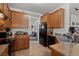 Kitchen featuring oak cabinets, laminate countertops, black appliances, and tiled flooring at 216 Goldfinch Ln, Summerville, SC 29485