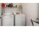 Functional laundry room featuring a washer, dryer, and practical shelving at 216 Goldfinch Ln, Summerville, SC 29485