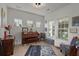 Cozy living room featuring a piano, comfortable seating, and natural light from multiple windows at 216 Goldfinch Ln, Summerville, SC 29485