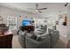 Open-concept living room with a comfortable gray sofa, ceiling fan, and abundant natural light at 216 Goldfinch Ln, Summerville, SC 29485