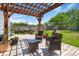 Backyard wooden pergola with outdoor seating and grill, perfect for enjoying shaded relaxation and entertaining at 216 Goldfinch Ln, Summerville, SC 29485