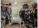 A spacious walk-in closet with ample hanging space and shelving, offering generous storage solutions and a window with blinds at 216 Goldfinch Ln, Summerville, SC 29485